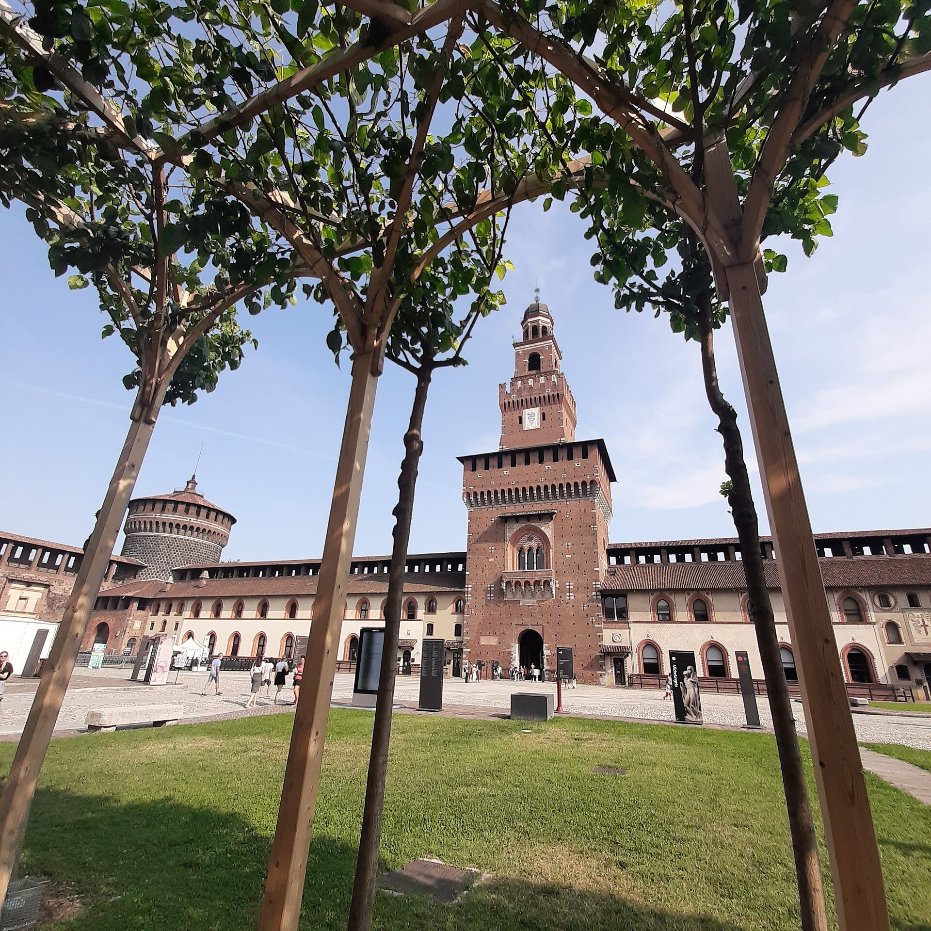 The castle's main courtyard with trees and the Filarete tower behind