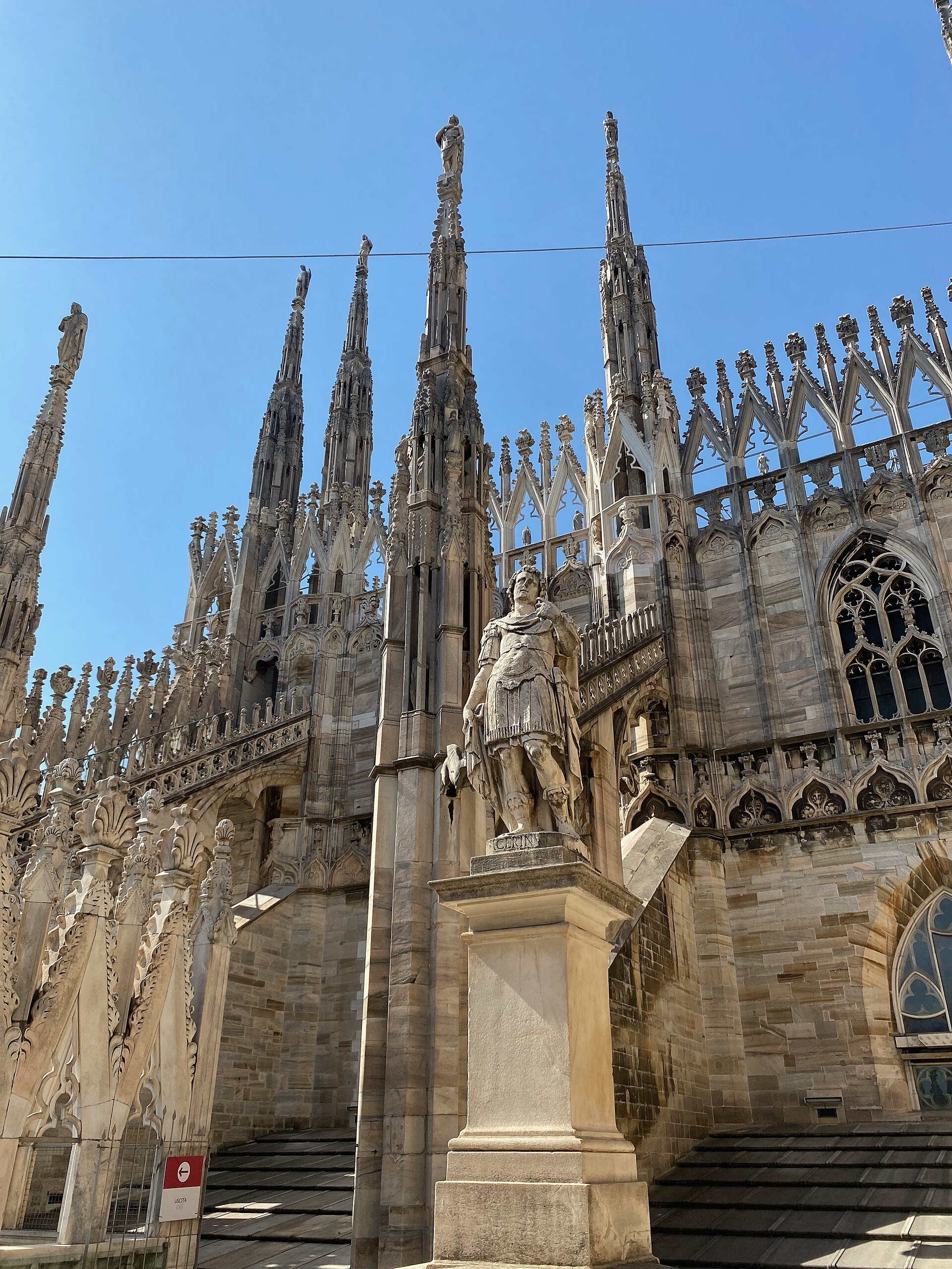Standing on the cathedral roof beside a statue, with the flying buttresses alongside