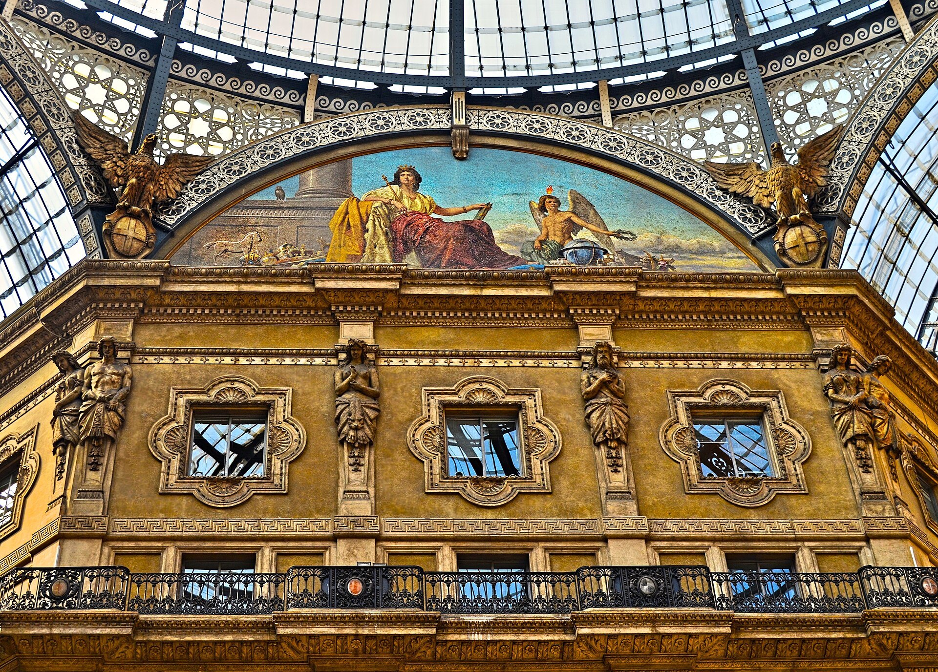 Looking up inside the Galleria at the painted lunettes and the iron and glass vault