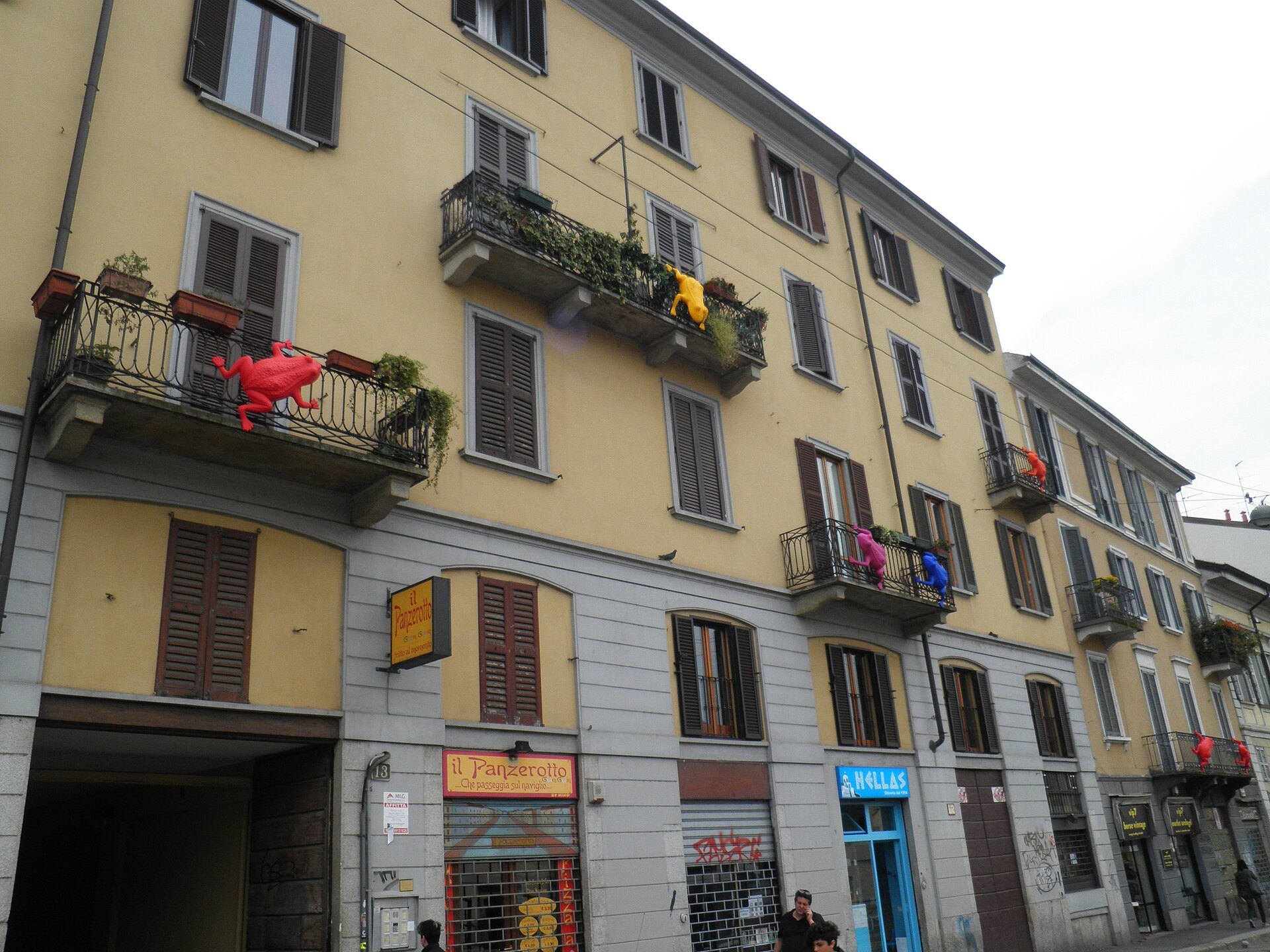 Canal-side houses on the Naviglio with balconies and shuttered windows