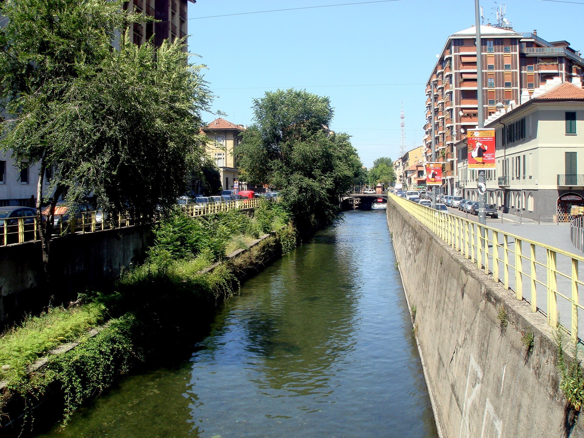 The Naviglio Pavese running between its stone banks with trees along one side