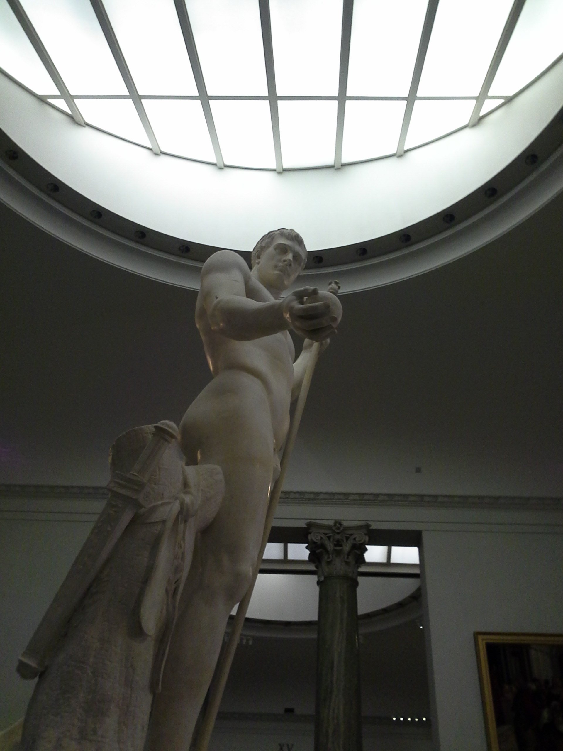 Canova's marble Napoleon standing under a circular skylight in a gallery at the Brera