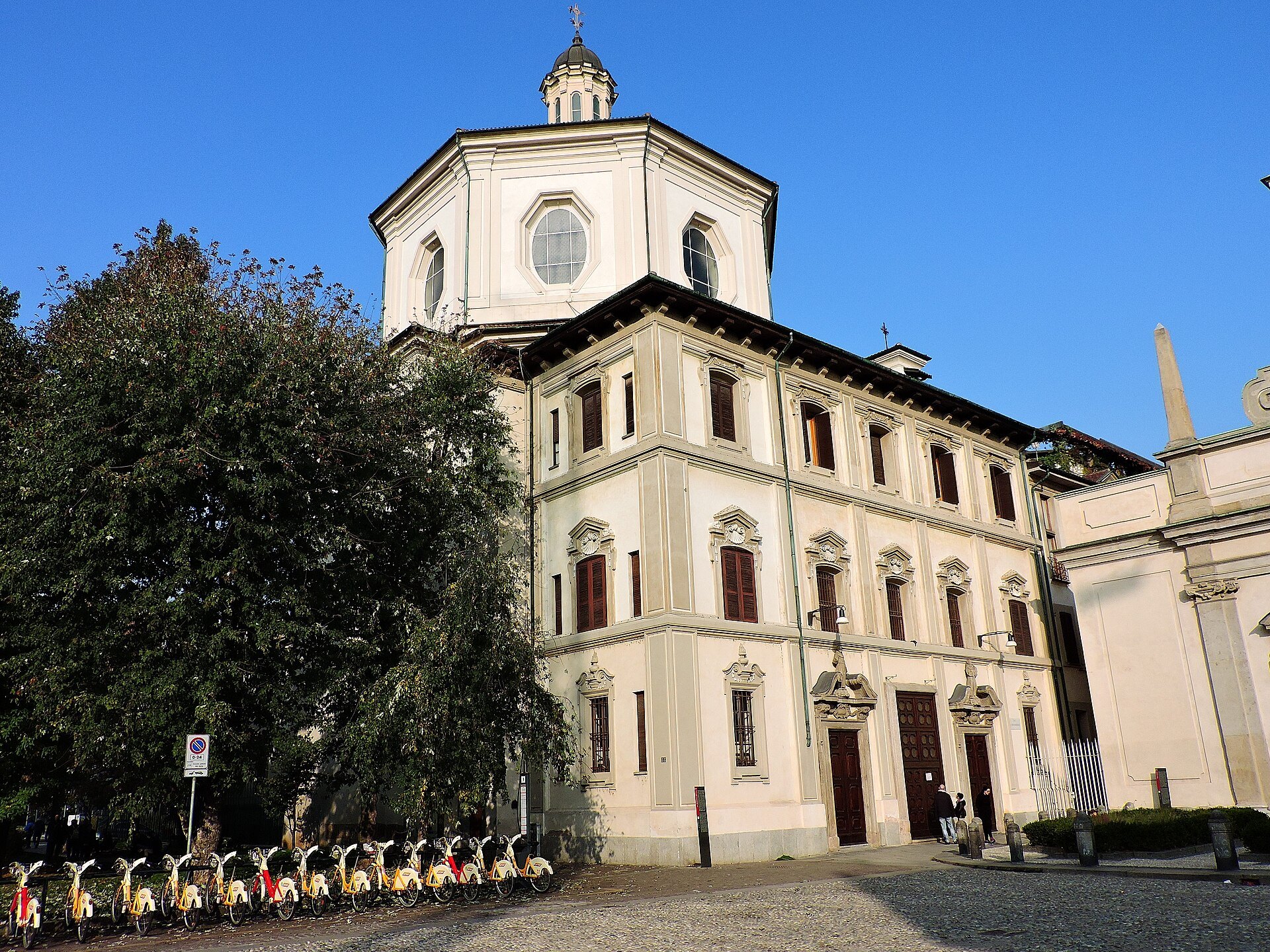 The plain front of the church of San Bernardino alle Ossa in sunlight