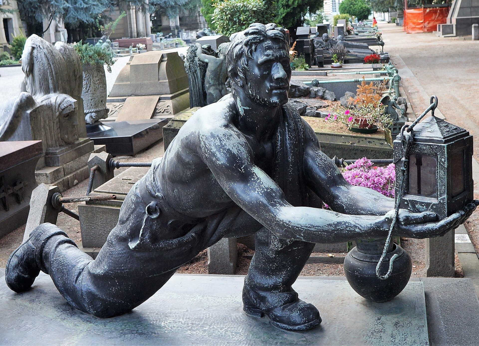 A bronze funerary figure holding a lantern at the Monumental Cemetery