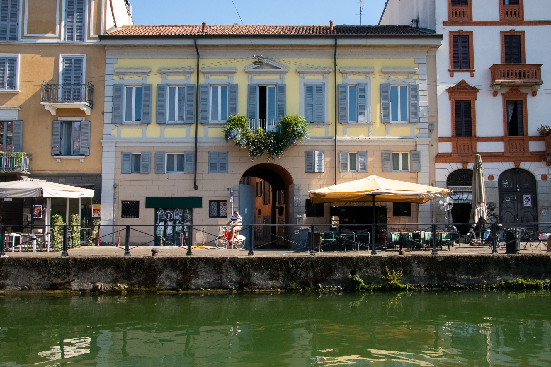 Canal view in Milan's Navigli District showcasing buildings and outdoor cafes